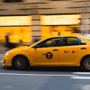 tilt shift photography of yellow taxi car