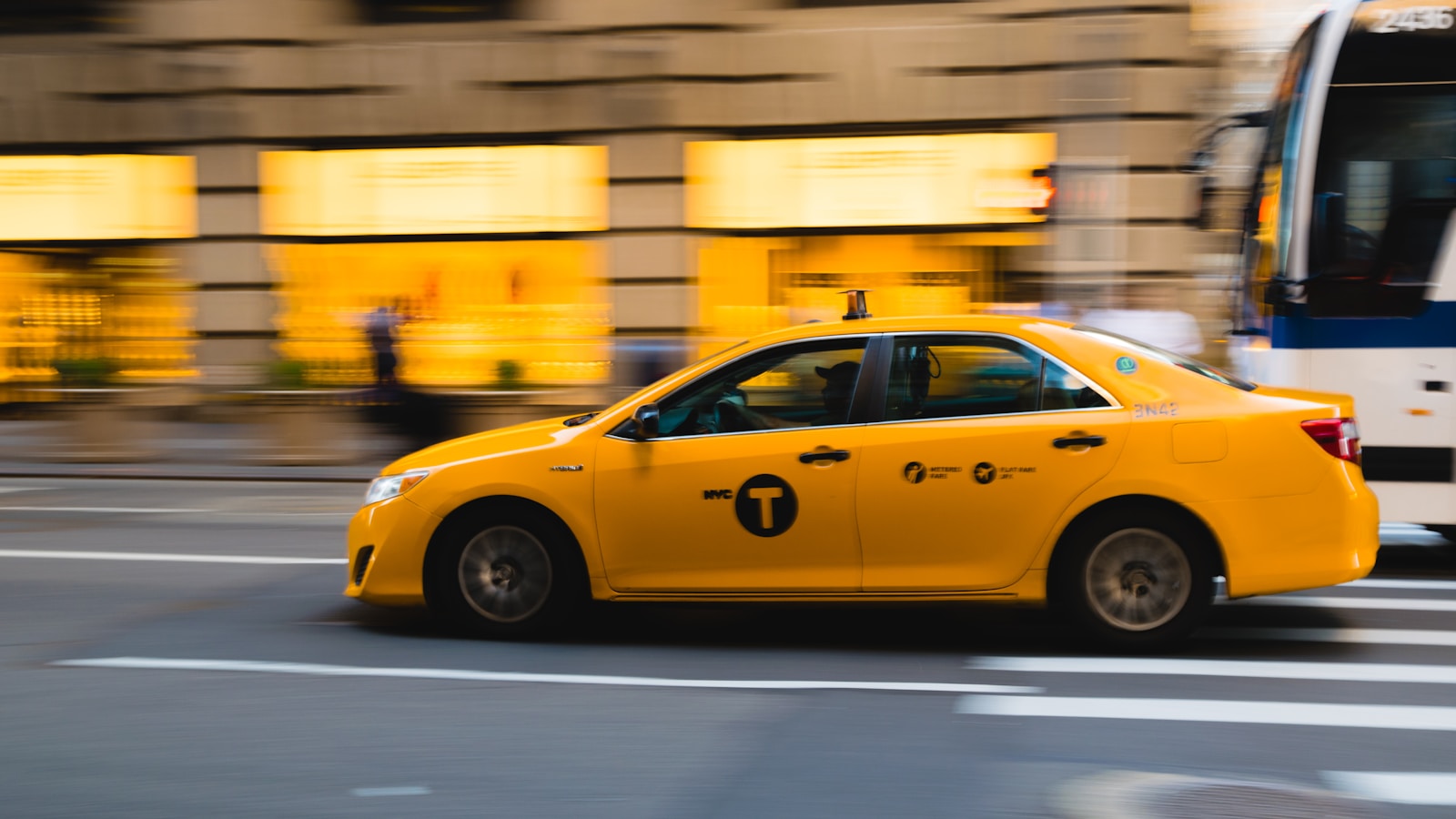 tilt shift photography of yellow taxi car