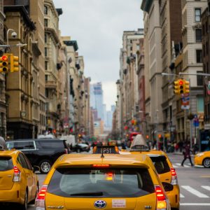 yellow cab in between of building